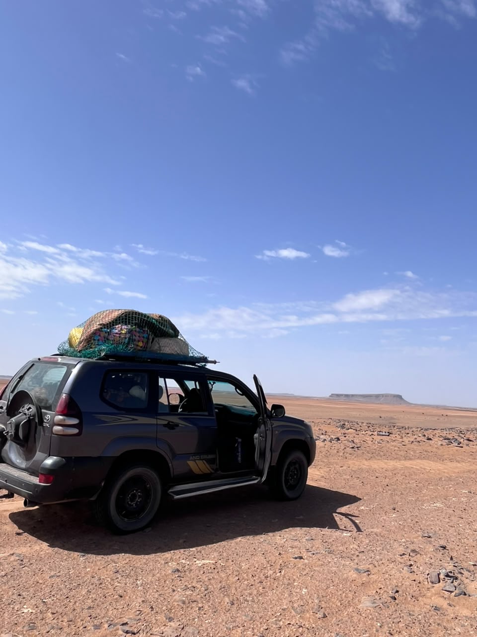 Our 4×4, loaded for the desert, on the stony plain